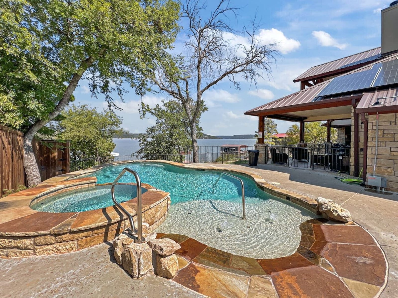 Swimming pool and hot tub on a flagstone deck overlooking Possum Kingdom Lake